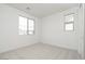 Bright bedroom with neutral carpet and two windows, perfect for natural light and a minimalist design at 1565 E Tiffany Way, Gilbert, AZ 85298