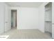 Clean, carpeted bedroom with a closet and doorway, offering a simple and functional space at 1565 E Tiffany Way, Gilbert, AZ 85298