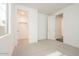 Bright bedroom features neutral carpet, a walk-in closet, and white paint at 1565 E Tiffany Way, Gilbert, AZ 85298