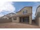 Rear exterior view of the home showcases the backyard with patio and fencing at 1565 E Tiffany Way, Gilbert, AZ 85298