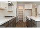 Modern kitchen features stainless steel appliances, large pantry, and island sink at 1565 E Tiffany Way, Gilbert, AZ 85298
