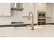 Kitchen island sink featuring white countertops, white cabinetry and gooseneck faucet at 1565 E Tiffany Way, Gilbert, AZ 85298