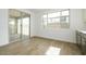 Bright living room featuring hardwood floors, large windows, and sliding glass doors at 1565 E Tiffany Way, Gilbert, AZ 85298