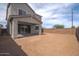 Large backyard featuring a covered patio and block fence, offering ample space for outdoor activities and privacy at 1571 E Tiffany Way, Gilbert, AZ 85298