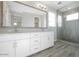 Bathroom featuring double sinks with quartz countertops, modern fixtures, and a glass-enclosed walk-in shower at 1571 E Tiffany Way, Gilbert, AZ 85298