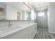This bathroom offers double sinks with quartz countertops, modern fixtures, and a glass-enclosed walk-in shower at 1571 E Tiffany Way, Gilbert, AZ 85298