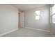 Bedroom with neutral walls, carpeted floor, closet, and a bright window overlooking the neighborhood at 1571 E Tiffany Way, Gilbert, AZ 85298