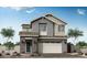 Charming two-story home featuring a gray facade, brick accents, and a two-car garage, all under a clear blue sky at 1571 E Tiffany Way, Gilbert, AZ 85298