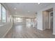 Expansive living room with wood-look tile flooring, recessed lighting, and neutral paint at 1571 E Tiffany Way, Gilbert, AZ 85298