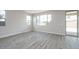 Bright room with wood-look tile, with several windows offering natural light and backyard access at 1571 E Tiffany Way, Gilbert, AZ 85298