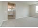 Spacious main bedroom featuring neutral carpet, light walls, and en suite bathroom entrance at 1571 E Tiffany Way, Gilbert, AZ 85298