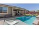 Beautiful backyard with a sparkling pool, covered patio, and a built-in barbecue grill for enjoying outdoor activities at 1644 E Joelle Dr, Casa Grande, AZ 85122