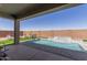 Expansive backyard with a sparkling pool, comfortable lounge chairs, and a putting green, offering endless outdoor fun at 1644 E Joelle Dr, Casa Grande, AZ 85122