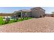 Backyard with artificial grass and rock features a covered patio, pool, and lounge chairs at 1644 E Joelle Dr, Casa Grande, AZ 85122