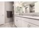 Bathroom with dual sinks, white cabinets, a large mirror, and tile floors at 1644 E Joelle Dr, Casa Grande, AZ 85122