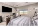 Bright bedroom with a television, window with blinds, and a workspace at 1644 E Joelle Dr, Casa Grande, AZ 85122
