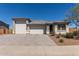 Charming single-story home featuring a three-car garage and desert landscaping at 1644 E Joelle Dr, Casa Grande, AZ 85122