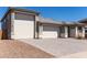 Spacious three-car garage with a paved driveway and well maintained landscaping at 1644 E Joelle Dr, Casa Grande, AZ 85122