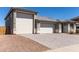 Spacious three-car garage with a paved driveway and well maintained landscaping at 1644 E Joelle Dr, Casa Grande, AZ 85122