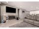 Inviting living room with gray sofa, tile floors, large TV, and electric fireplace at 1644 E Joelle Dr, Casa Grande, AZ 85122