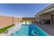 Inviting backyard with a refreshing pool, built-in seating, putting green and an outdoor cooking area, perfect for entertaining at 1644 E Joelle Dr, Casa Grande, AZ 85122