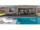 Backyard featuring a swimming pool with built-in seating, a patio with outdoor furniture, and a barbecue grill for entertaining at 1644 E Joelle Dr, Casa Grande, AZ 85122