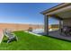 Inviting backyard featuring a sparkling pool, well-manicured artificial turf, and poolside seating, perfect for outdoor relaxation at 1644 E Joelle Dr, Casa Grande, AZ 85122