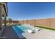 Beautiful backyard featuring a sparkling pool with a basketball hoop and lounge chairs, perfect for relaxation and fun at 1644 E Joelle Dr, Casa Grande, AZ 85122