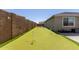 Wide putting green features multiple holes for added challenge with surrounding privacy wall and a well manicured backyard at 1644 E Joelle Dr, Casa Grande, AZ 85122