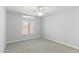 Neutral bedroom with a window, ceiling fan and gray carpet at 1650 S Crismon Rd # 6, Mesa, AZ 85209