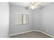 Neutral bedroom with a window, ceiling fan and gray carpet at 1650 S Crismon Rd # 6, Mesa, AZ 85209