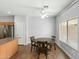 Cozy dining area with natural light, a ceiling fan, and seamless access to the adjacent kitchen at 1650 S Crismon Rd # 6, Mesa, AZ 85209