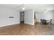 Spacious open-concept living room featuring wood-look floors, neutral walls, and seamless flow to dining area at 1650 S Crismon Rd # 6, Mesa, AZ 85209