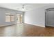 Bright living room with wood-look floors, large windows, and a sliding glass door for outdoor access at 1650 S Crismon Rd # 6, Mesa, AZ 85209