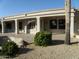 The covered patio overlooks meticulously designed landscaping and serene outdoor space at 18001 N Timber Ridge Dr, Surprise, AZ 85374