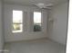 Bright bedroom with two windows, shutters, and a ceiling fan at 18001 N Timber Ridge Dr, Surprise, AZ 85374