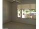 Bright bedroom offers views of an outdoor kitchen, grill, and serene green space at 18001 N Timber Ridge Dr, Surprise, AZ 85374
