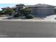 Charming single-story home featuring a two-car garage and desert landscaping at 18001 N Timber Ridge Dr, Surprise, AZ 85374
