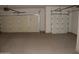 Spacious two car garage with epoxy flooring and two garage doors at 18001 N Timber Ridge Dr, Surprise, AZ 85374