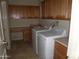 Laundry room with washer, dryer, sink, countertops, and built-in cabinets at 18001 N Timber Ridge Dr, Surprise, AZ 85374