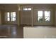 An open living room with tile flooring is filled with natural light at 18001 N Timber Ridge Dr, Surprise, AZ 85374