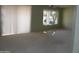 A comfortable living room has neutral carpet and a bright window at 18001 N Timber Ridge Dr, Surprise, AZ 85374