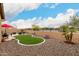 Spacious backyard featuring desert landscaping, artificial turf, and a cozy outdoor seating area at 18368 W Long Lake Rd, Goodyear, AZ 85338