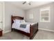 Comfortable bedroom with a ceiling fan, shuttered windows and an elegant wood-framed bed at 18368 W Long Lake Rd, Goodyear, AZ 85338