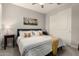 A bedroom with a queen bed, bedside table and closet at 18368 W Long Lake Rd, Goodyear, AZ 85338