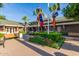 Exterior view of the community clubhouse with benches, manicured landscape and flagpoles at 18368 W Long Lake Rd, Goodyear, AZ 85338