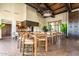Open dining area featuring high top tables, wood beam ceiling, and decorative hanging light fixture at 18368 W Long Lake Rd, Goodyear, AZ 85338