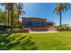 Charming community event center with lush green lawn and blue windows and doors at 18368 W Long Lake Rd, Goodyear, AZ 85338