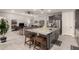 Modern island kitchen featuring granite countertops, breakfast bar, and stainless appliances at 18368 W Long Lake Rd, Goodyear, AZ 85338