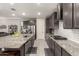 Modern kitchen with granite countertops, stainless appliances, and white subway backsplash at 18368 W Long Lake Rd, Goodyear, AZ 85338